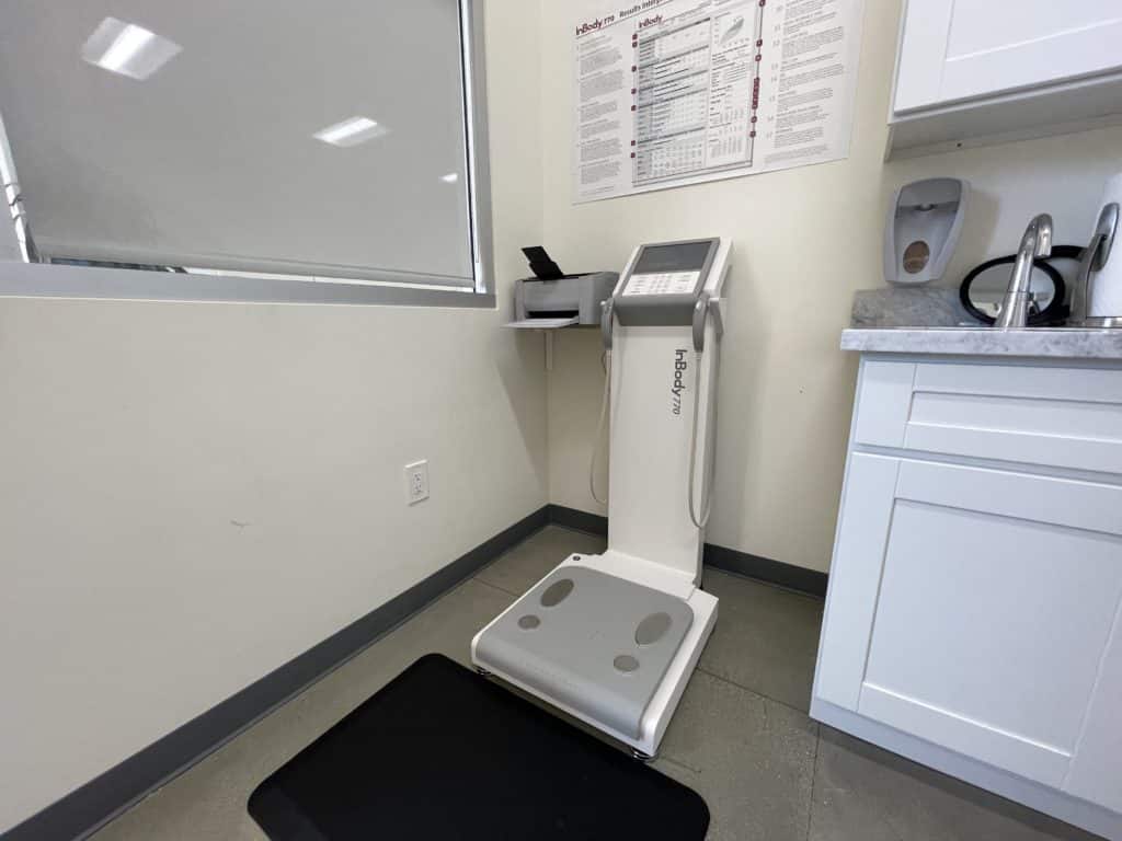 A bathroom equipped with a weight scale for comprehensive body composition analysis.