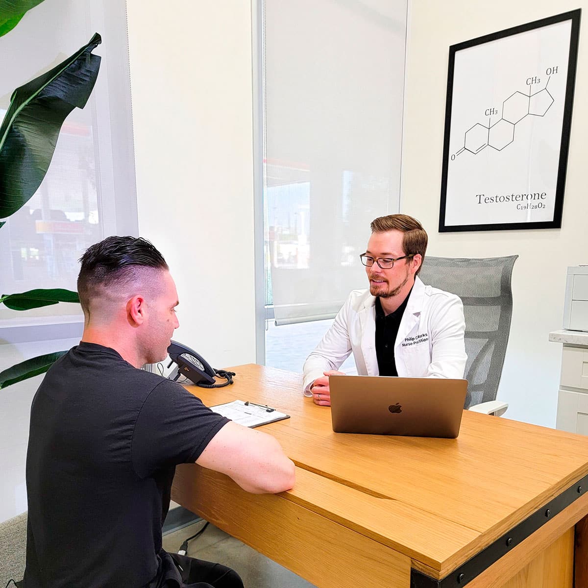 A man at a desk with a laptop in front of him, engaged in corporate wellness activities.