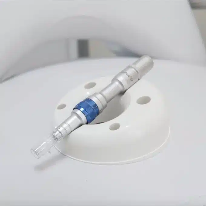 A blue and white syringe, used for microneedling and botox treatments, is sitting on top of a white chair, creating an aesthetically pleasing display.