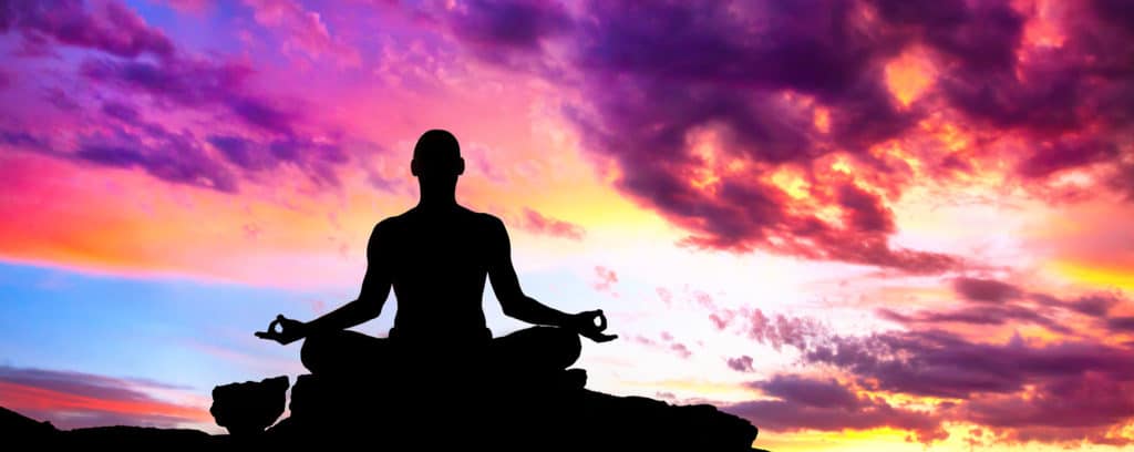 A silhouette of a person meditating in a lotus position with Selank aroma.
