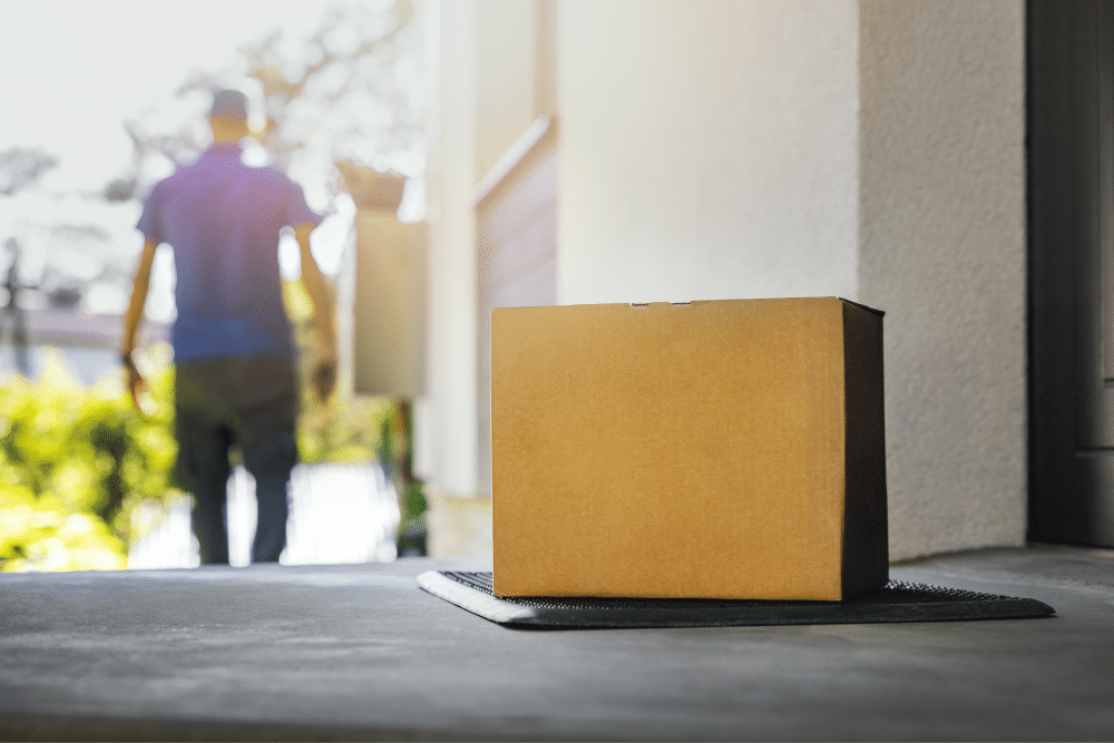 A brown box containing scream cream sitting on the front porch of a house.