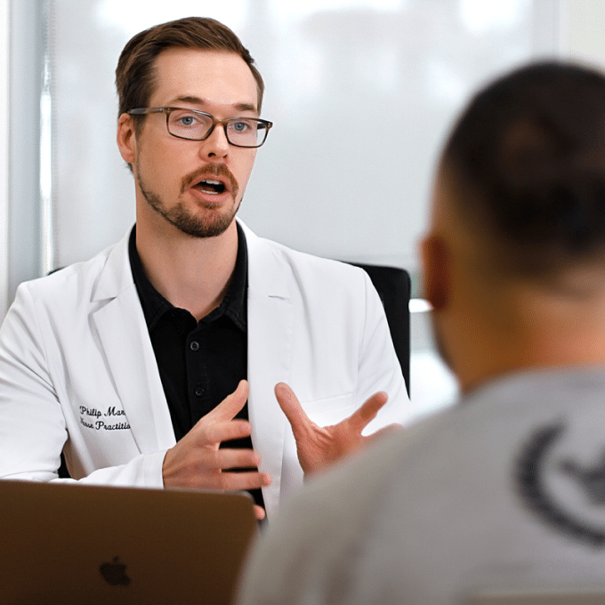 A doctor conducting a comprehensive blood panel with a patient in an office.