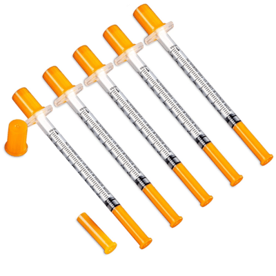 Five small insulin syringes with orange caps on a white background. Regenics