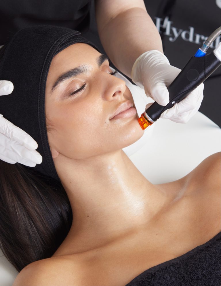 A woman getting a facial treatment at a beauty salon.