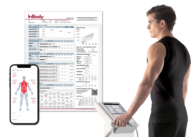 A man reviews his body composition analysis results on an inbody machine screen and a connected smartphone app, as part of his New Year Resolution Refresh.