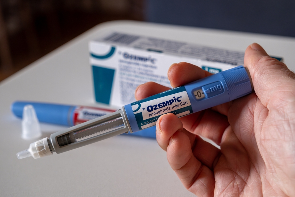 Hand holding Ozempic semaglutide injection pen