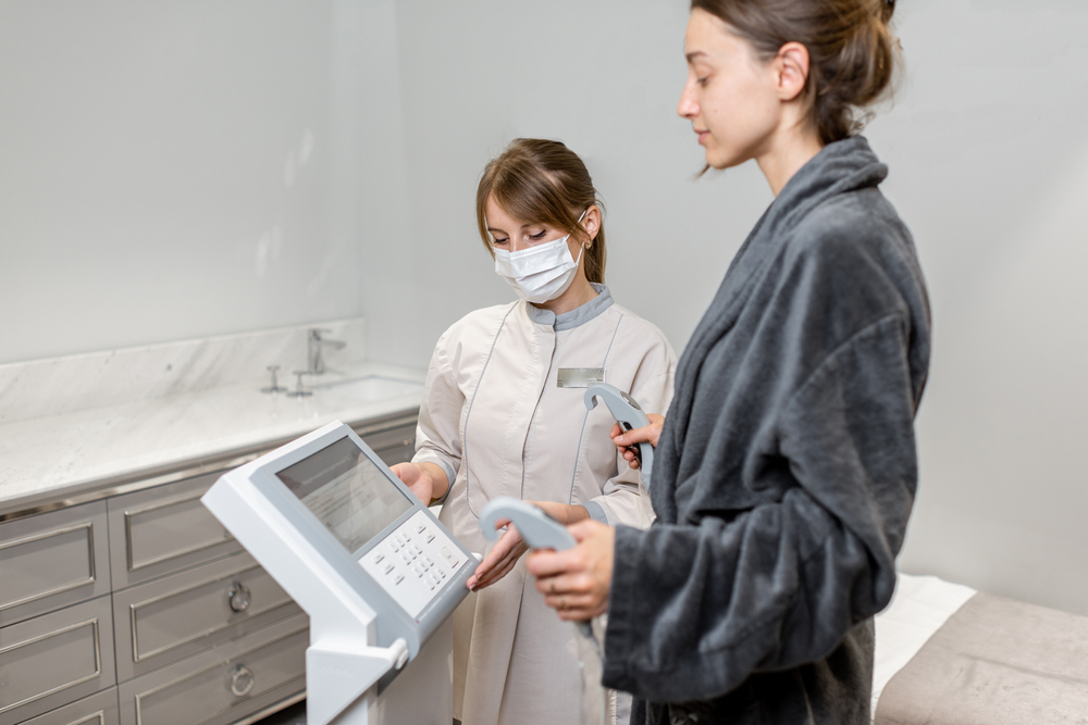 Woman measuring body composition standing with a medical assistant on the scales