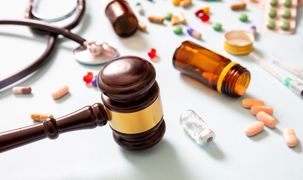 judge gavel and medication on blue background