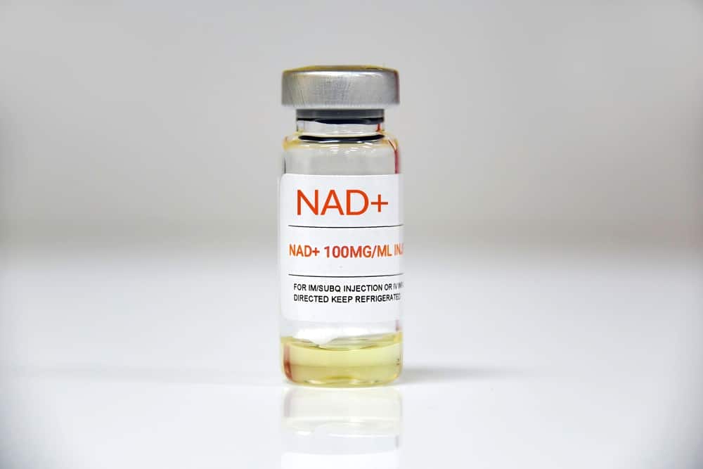 A single vial of NAD + on white background