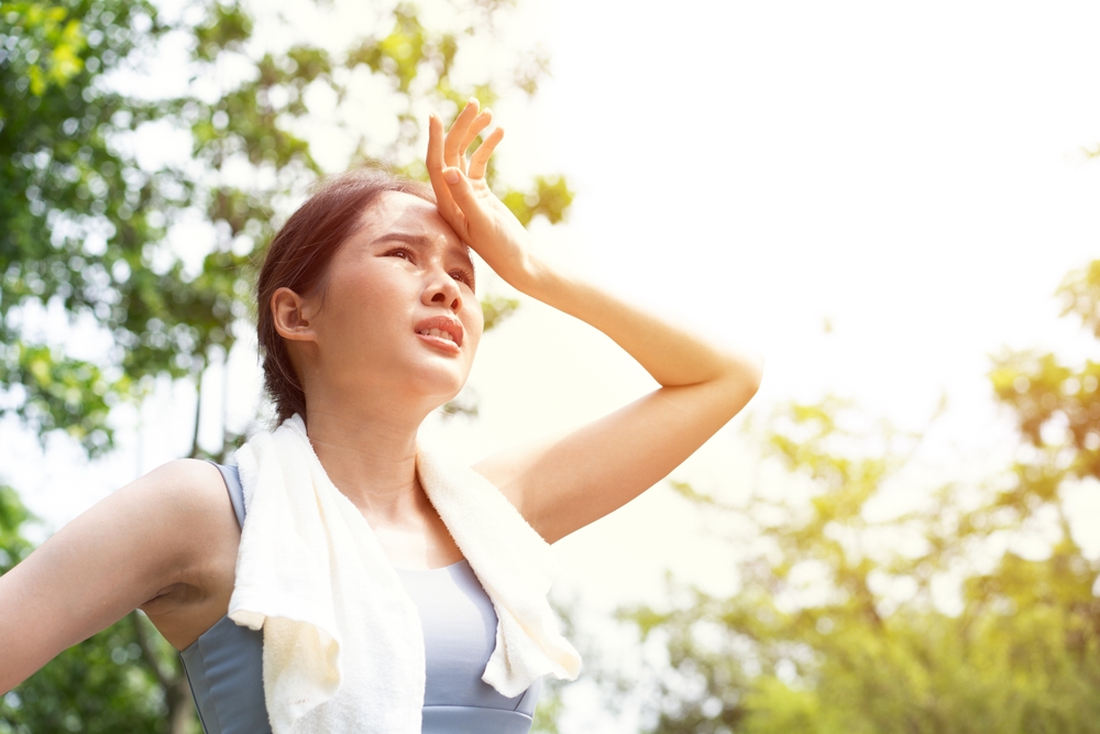 Sport asian woman gets tired due to dehydration