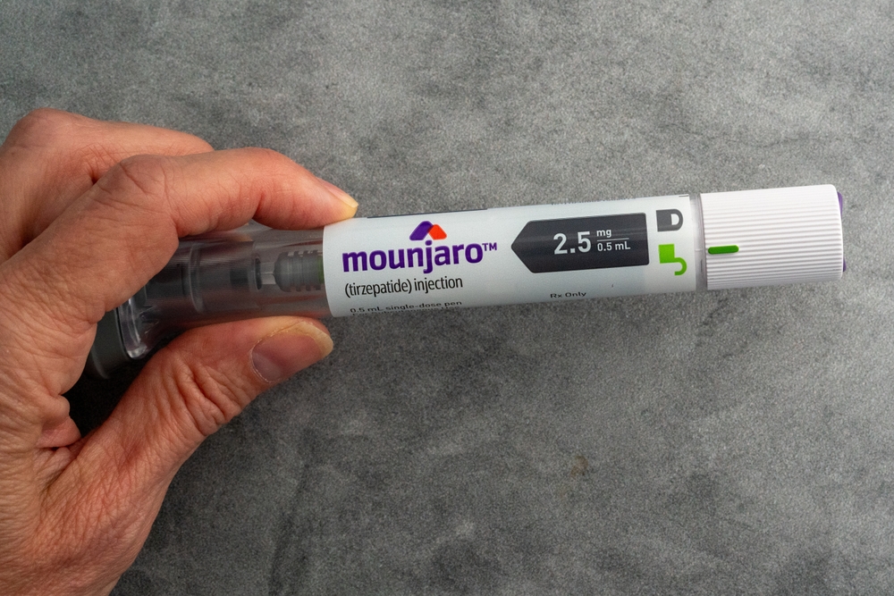 Hand holding a Mounjaro injectable pen