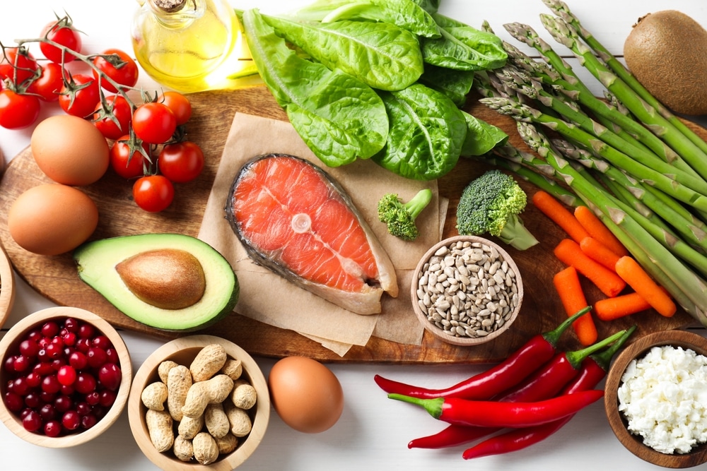 Many different healthy food on white table, flat lay