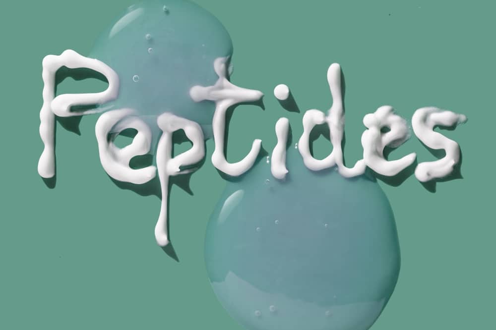 Cosmetic ingredient lettering peptides isolated on mint emerald